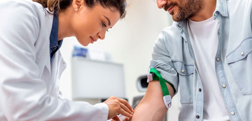 friendly-hospital-phlebotomist-collecting-blood-sample-from-patient-lab-preparation-blood-test-by-female-doctor-medical-uniform-table-white-bright-room